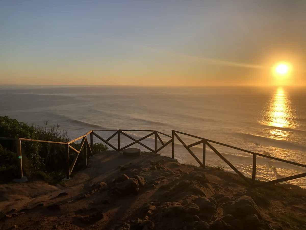 Golden sunset over the ocean from a cliffside lookout